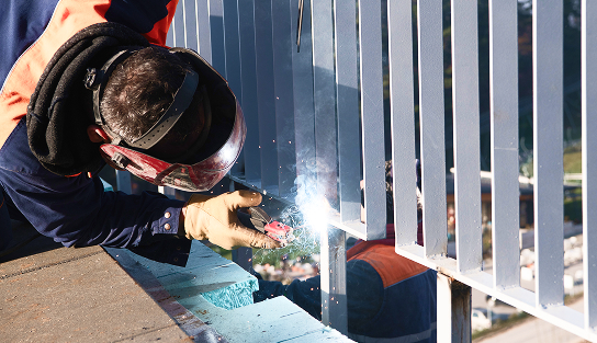 industrial-welder-skillfully-crafts-a-metal-fence